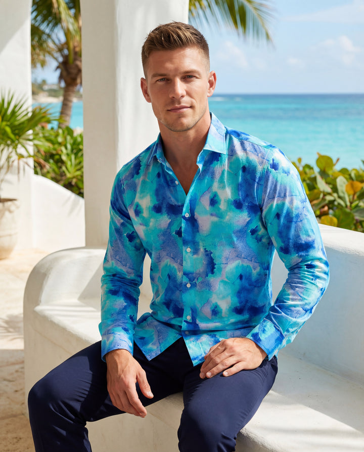 This sophisticated long-sleeve button-up shirt features a vibrant blue watercolor abstract print, blending shades of turquoise and navy. Crafted with a classic collar and a tailored fit, it offers a refreshing, artistic aesthetic perfect for making a bold
