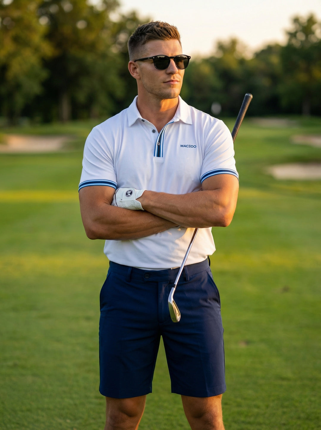 This high-performance white polo shirt features a structured collar and contrasting blue striped accents on the placket and cuffs. Tailored with moisture-wicking fabric and a subtle chest logo, it offers a sharp, modern fit paired here with vibrant cobalt