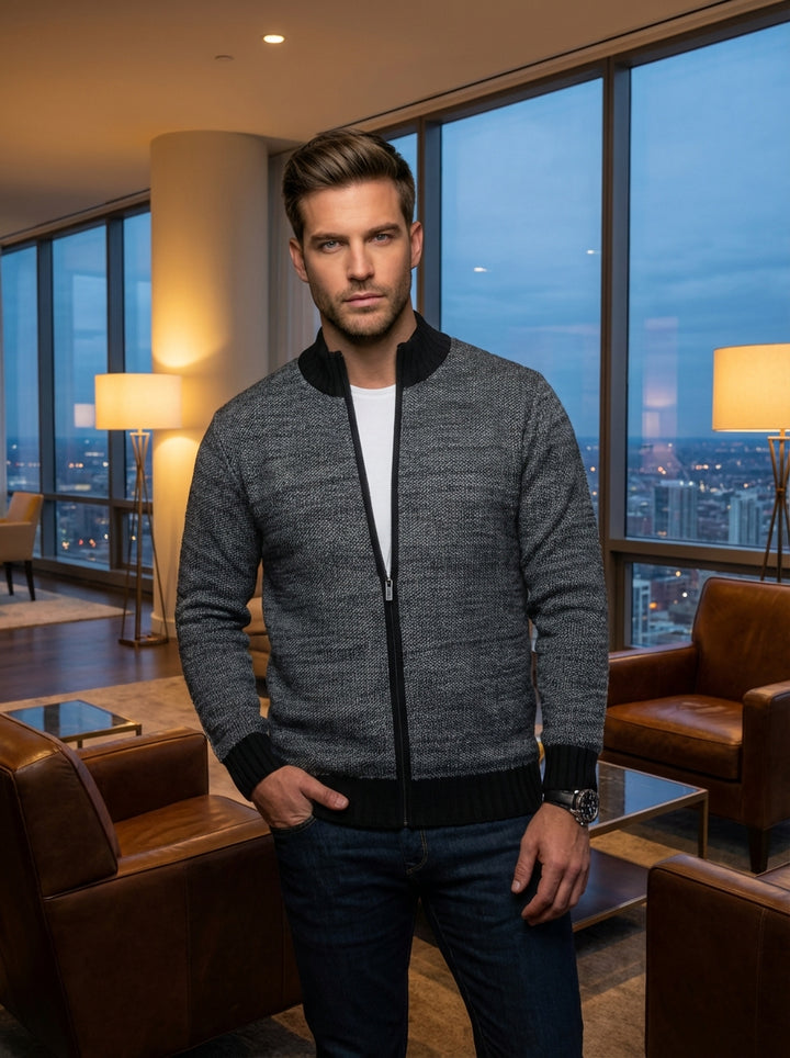 This men's zip-up cardigan features a sophisticated grey textured knit with contrasting black ribbed trim on the collar, cuffs, and hem. Designed for a tailored fit, it offers a modern look that seamlessly bridges the gap between casual and formal.