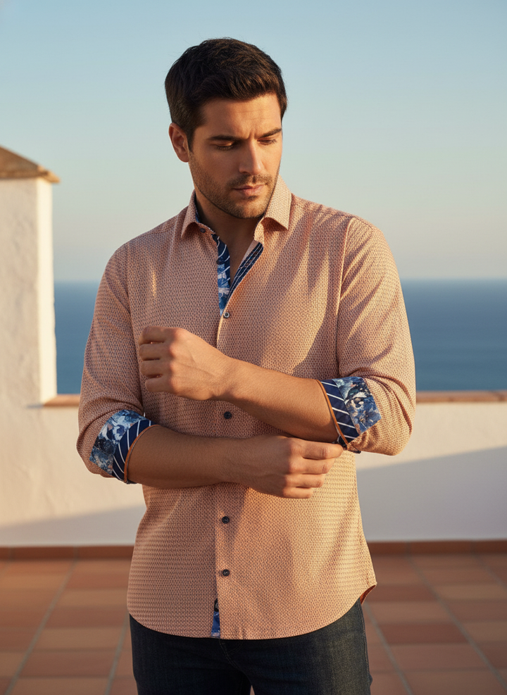 This peach micro-patterned button-down epitomizes modern sophistication. Distinguished by vibrant contrast floral and striped inner cuffs and collar, it offers a refined silhouette with a bold, creative twist, perfect for the style-conscious professional.