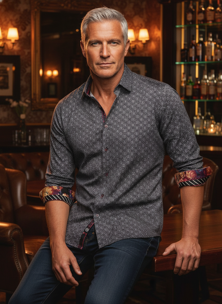 Elevate your wardrobe with this intricately patterned button-down, featuring bold floral and striped cuff accents. Tailored for a modern fit, it seamlessly blends classic sophistication with an adventurous, artisanal edge for the discerning gentleman.