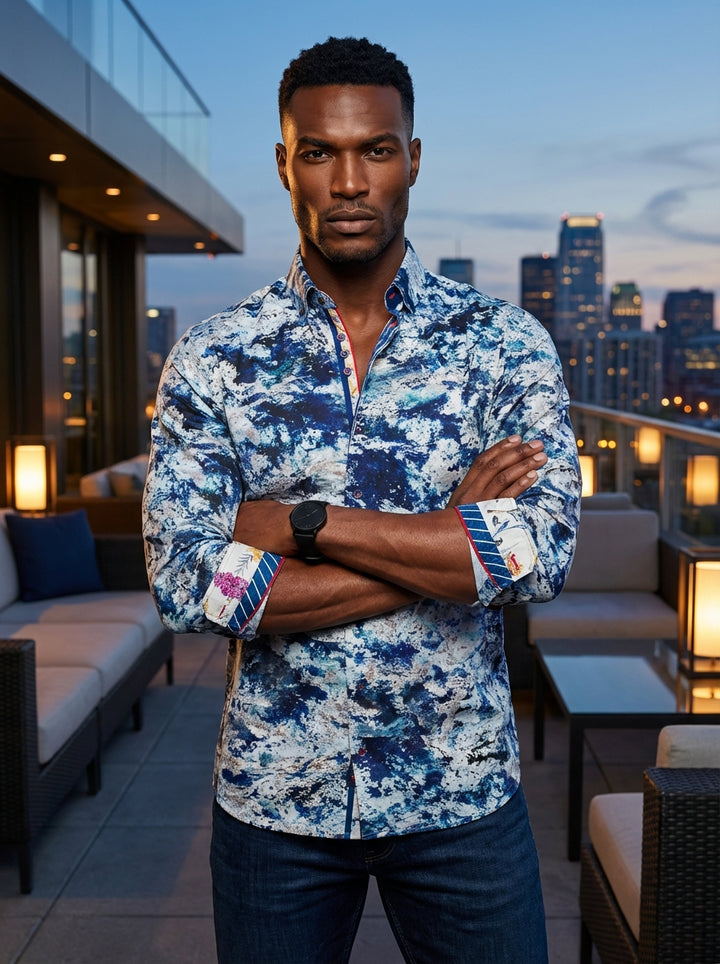 This premium long-sleeved shirt features a striking blue and white abstract marble print. It showcases intricate details including a contrast floral inner cuff, red piping, and a textured button-down collar, perfect for men seeking a sophisticated yet bol
