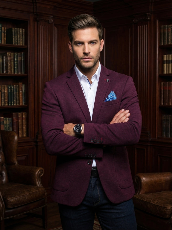 Elevate your smart-casual wardrobe with this sophisticated textured burgundy blazer. Featuring a tailored fit, unique lapel pin detail, and a vibrant patterned pocket square, it pairs perfectly with a crisp white button-down and dark denim for a modern, r