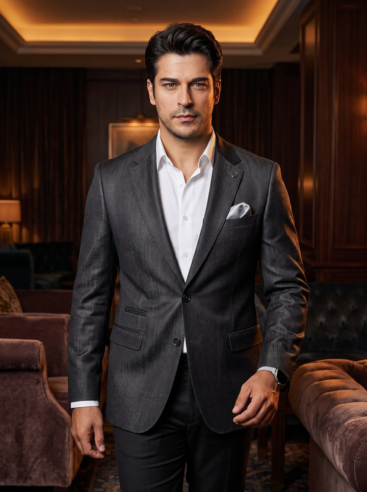 A charcoal grey tailored blazer featuring a textured finish, peaked lapels, and a single-button closure. It is paired with a crisp white dress shirt and a coordinated silver pocket square for a sophisticated, modern formal aesthetic.