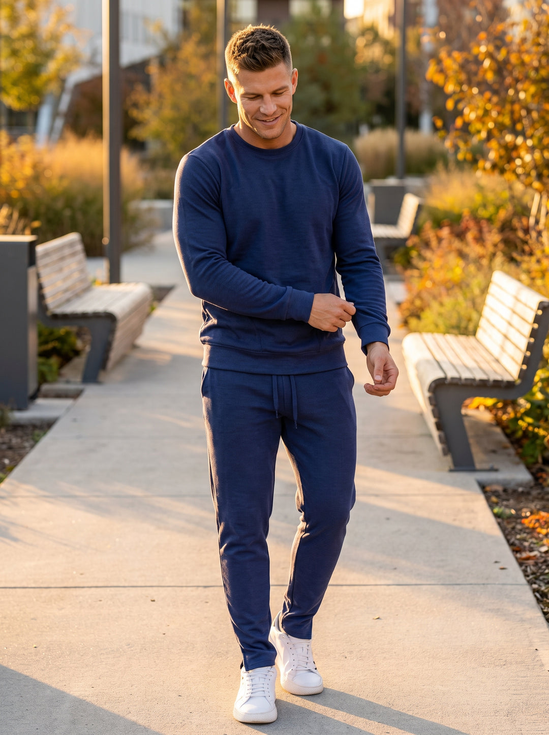 These premium navy blue joggers feature a modern ribbed texture and a tapered silhouette for a sleek fit. Crafted with a comfortable drawstring waistband and matching cuffed hems, they offer a refined take on classic, high-performance athletic loungewear 