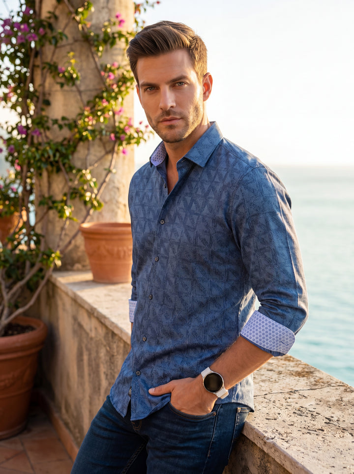This sophisticated men's button-down shirt features a rich navy blue hue with a subtle geometric pattern and textured jacquard finish. The contrasting light blue patterned inner cuffs and collar add a modern touch, making it ideal for stylish semi-formal 