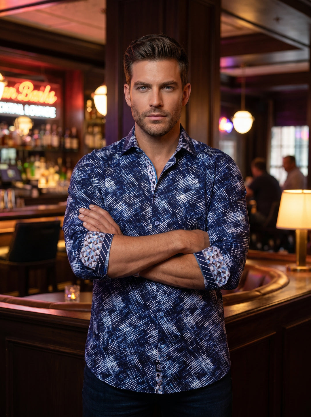 This tailored button-down shirt features a sophisticated indigo and white abstract geometric print with cross-hatch detailing. Contrasting patterned cuffs and collar lining add a modern flair, while the premium fabric ensures a sharp, structured fit suita