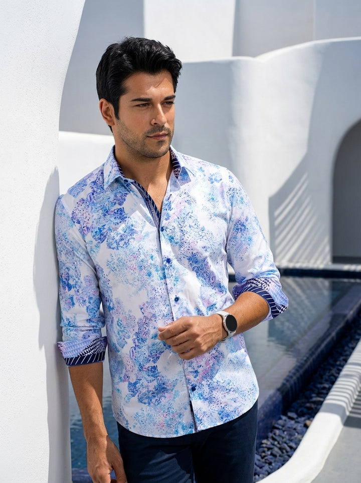 This sophisticated long-sleeve button-down features a crisp white base adorned with an intricate blue and purple paisley-inspired abstract print. Contrast navy geometric trim on the inner collar and cuffs adds a modern architectural touch to this versatil