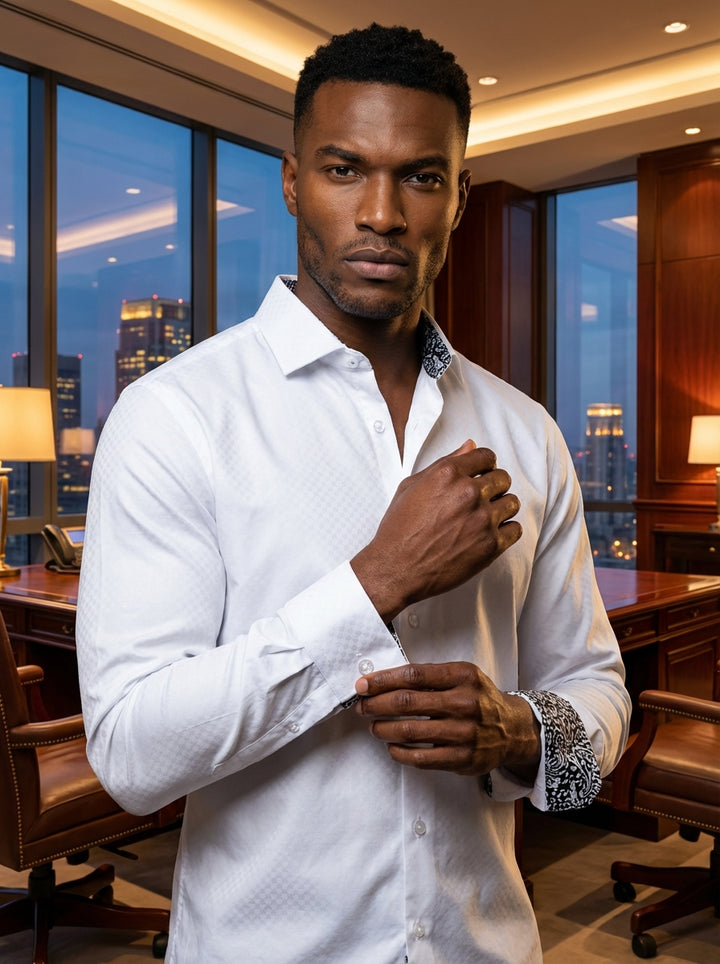 This elegant white Masutto dress shirt features a subtle tonal diamond weave pattern. Designed with a spread collar and double-button cuffs, it showcases a sophisticated black and white paisley contrast lining inside the collar and cuffs for a modern flai