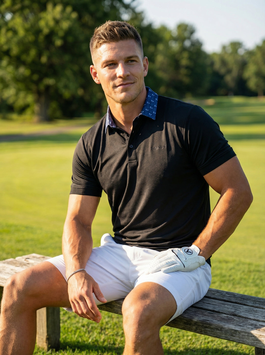 This sleek black performance polo features a unique patterned blue inner collar for a touch of hidden personality. Crafted with a tailored fit and breathable stretch fabric, it offers a sophisticated athletic look perfect for transitions from court to clu