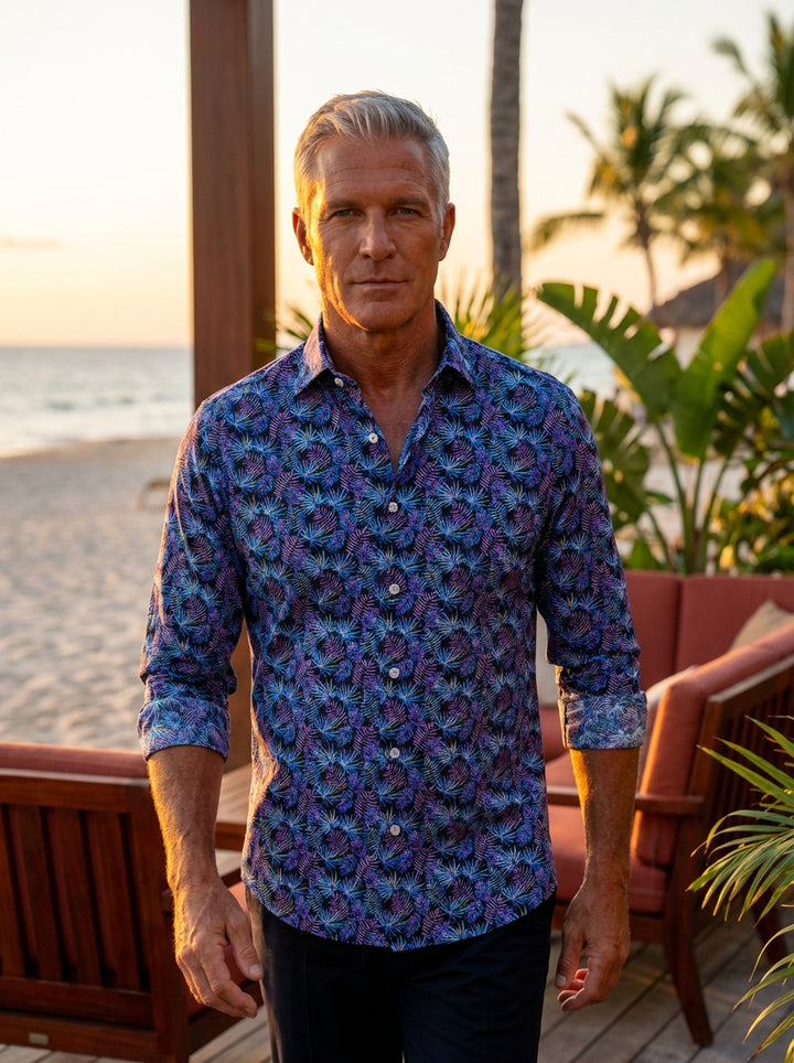 This Masutto button-down shirt features a vibrant all-over tropical palm leaf print in striking shades of electric blue, purple, and magenta. Crafted for a modern fit, the dark base highlights the intricate botanical details, perfect for making a bold sta