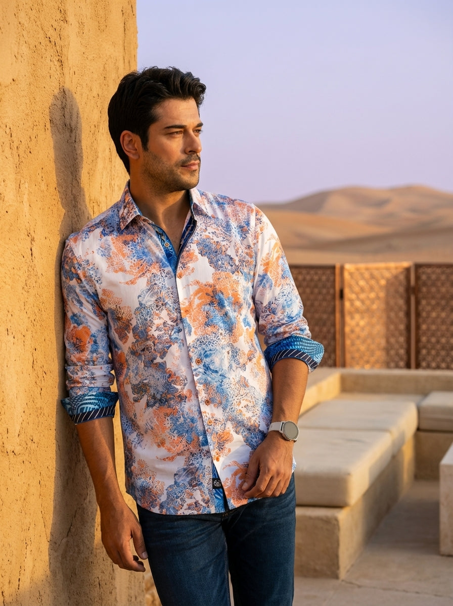 This premium long-sleeved button-down shirt features a vibrant white base adorned with an intricate blue and orange abstract floral motif. Design details include contrasting geometric patterns on the inner collar and cuffs, adding a modern, sophisticated 