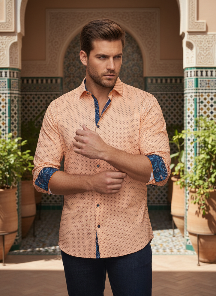 Exude effortless charm in this peach micro-dot shirt, featuring striking navy paisley contrast details on the collar and cuffs. Meticulously tailored for a sharp, modern silhouette, it's the perfect statement piece for transitions from boardroom to evenin