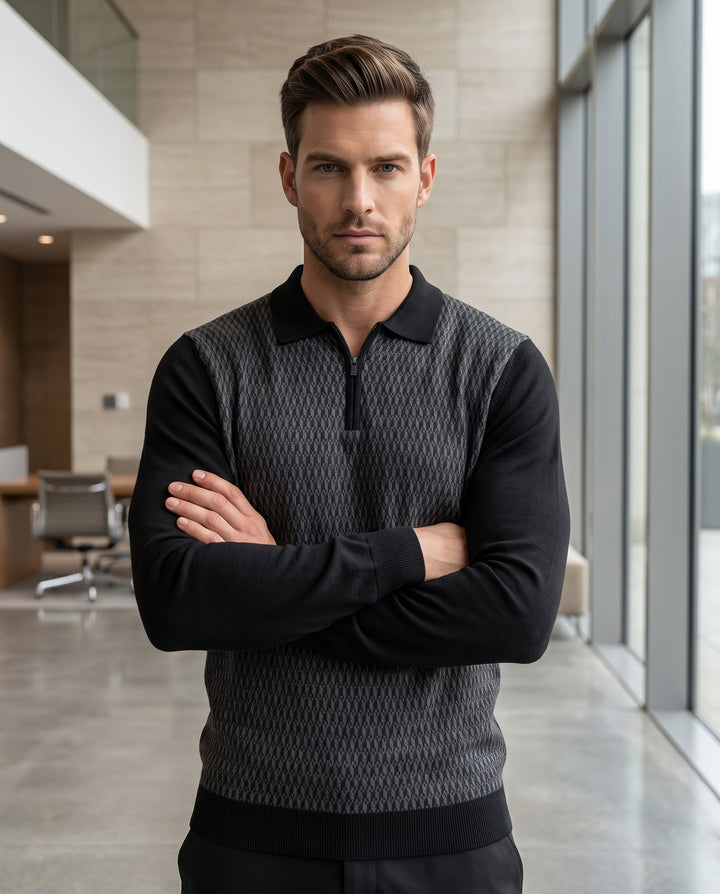 A sophisticated long-sleeve knit polo featuring a grey geometric-patterned front panel and solid black sleeves. The design includes a ribbed black collar, a functional quarter-zip neckline, and ribbed cuffs and hem for a tailored fit.
