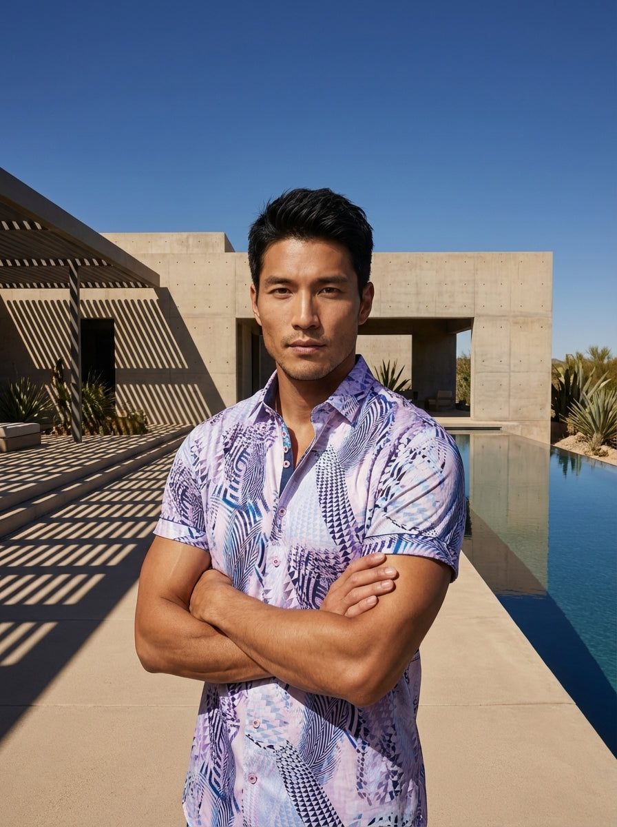 This modern short-sleeve button-down features a vibrant lavender and blue geometric abstract print. Crafted with a tailored fit, it includes a sophisticated inner collar contrast and cuffed sleeves, making it a bold statement piece for any contemporary ca