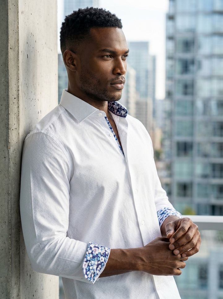 This Masutto white dress shirt features a sophisticated subtle geometric jacquard pattern. Crafted with high-quality fabric, it includes a modern spread collar and contrasting floral interior trims on the neck and cuffs for a stylish, contemporary finish 