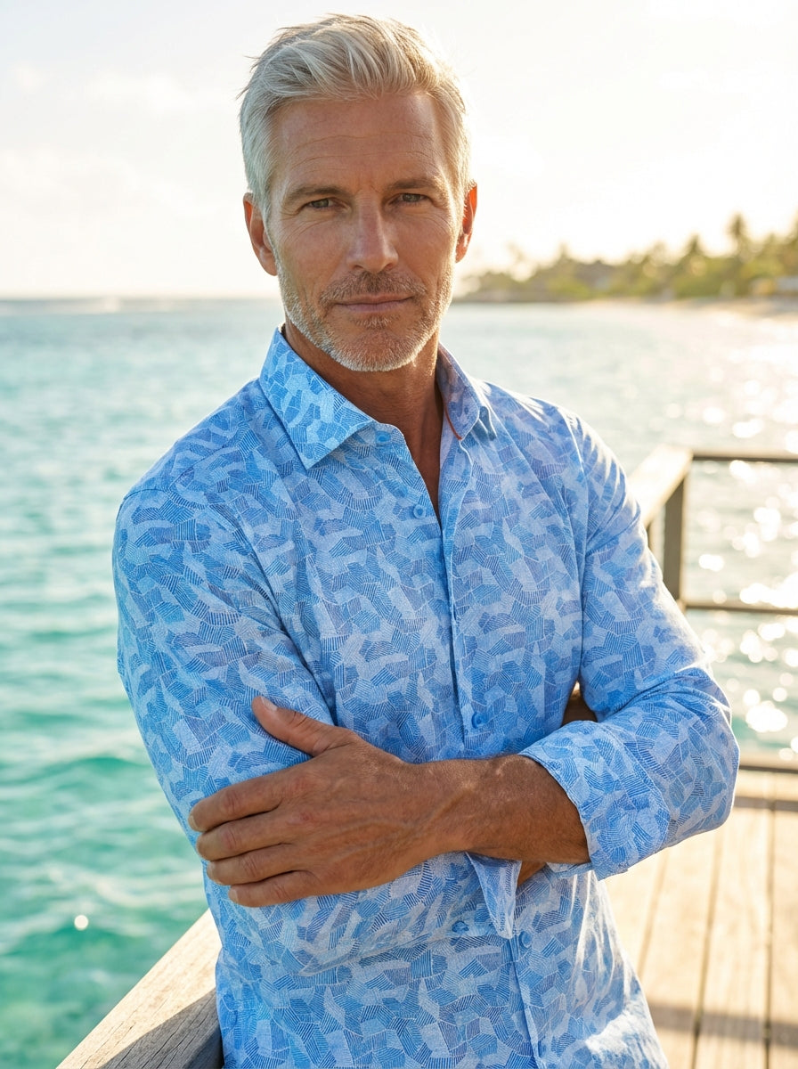This Masutto long-sleeved button-down shirt features a vibrant light blue mosaic geometric pattern. The intricate linework creates a dynamic textured effect on high-quality fabric, finished with a classic collar and clear blue buttons for a sophisticated,