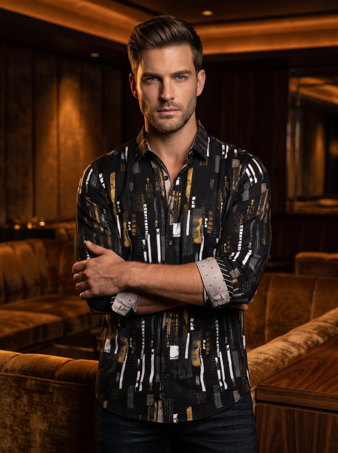 This sophisticated men's button-down shirt features a dynamic abstract brushstroke pattern in white, gold, and grey over a black base. Crafted with contrasting interior cuffs and a classic collar, it offers a contemporary artistic look for the modern gent