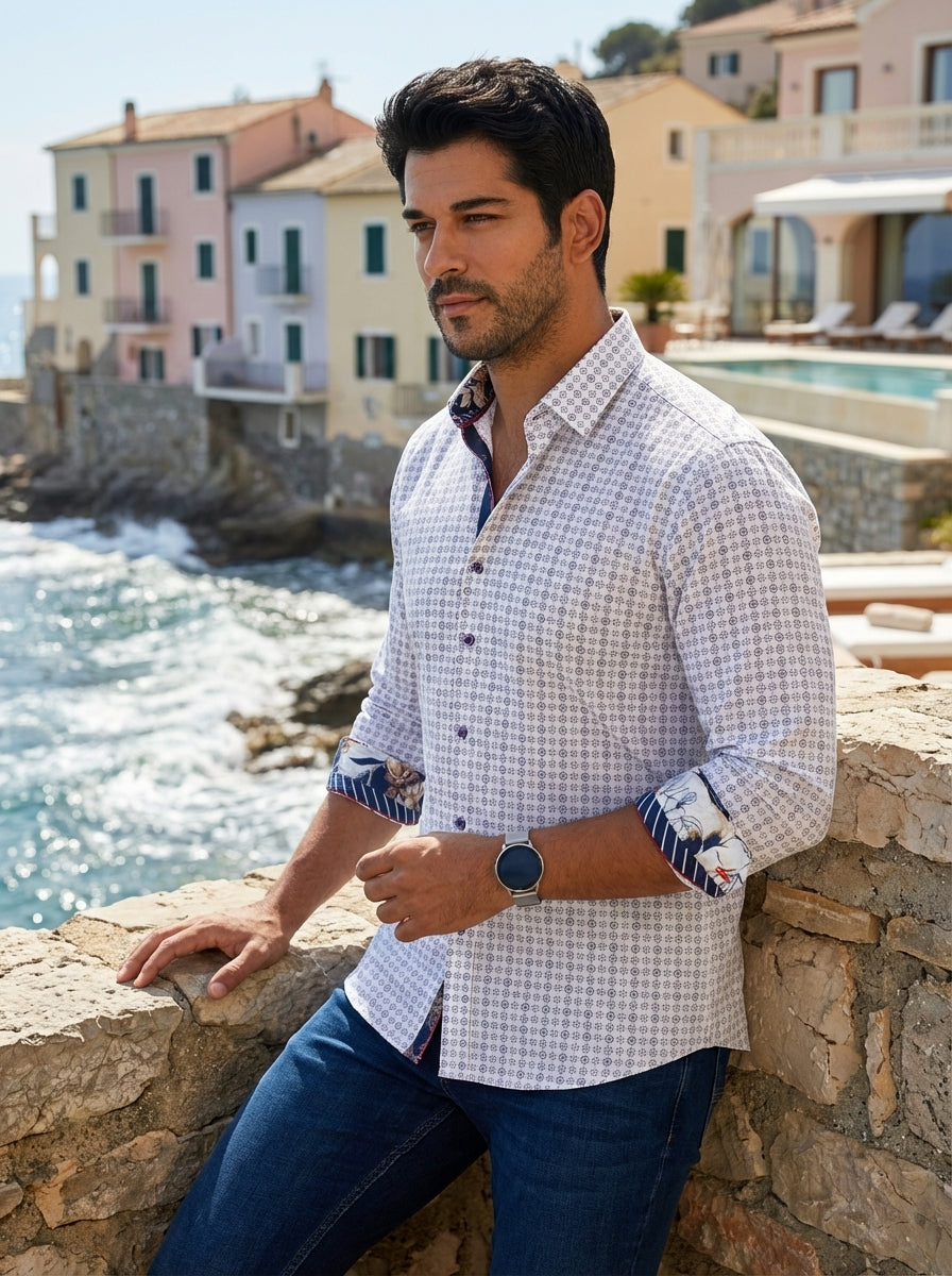 This premium white button-down shirt features an intricate navy and grey geometric pattern throughout. Its distinctive design includes a contrasting floral and striped lining on the collar and cuffs, adding a touch of sophisticated flair to a classic tail