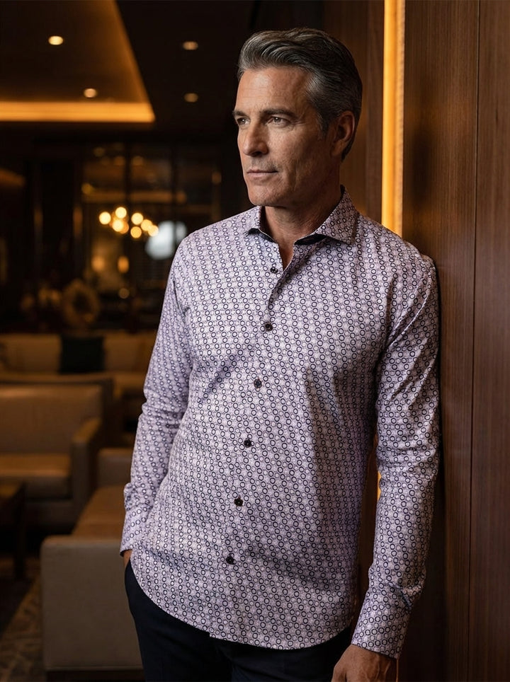 This sophisticated long-sleeve button-down shirt features a complex, interlocking geometric honeycomb pattern in soft lavender and white hues. Crafted for a slim fit, it includes dark accent buttons and a refined collar, blending classic tailoring with mo