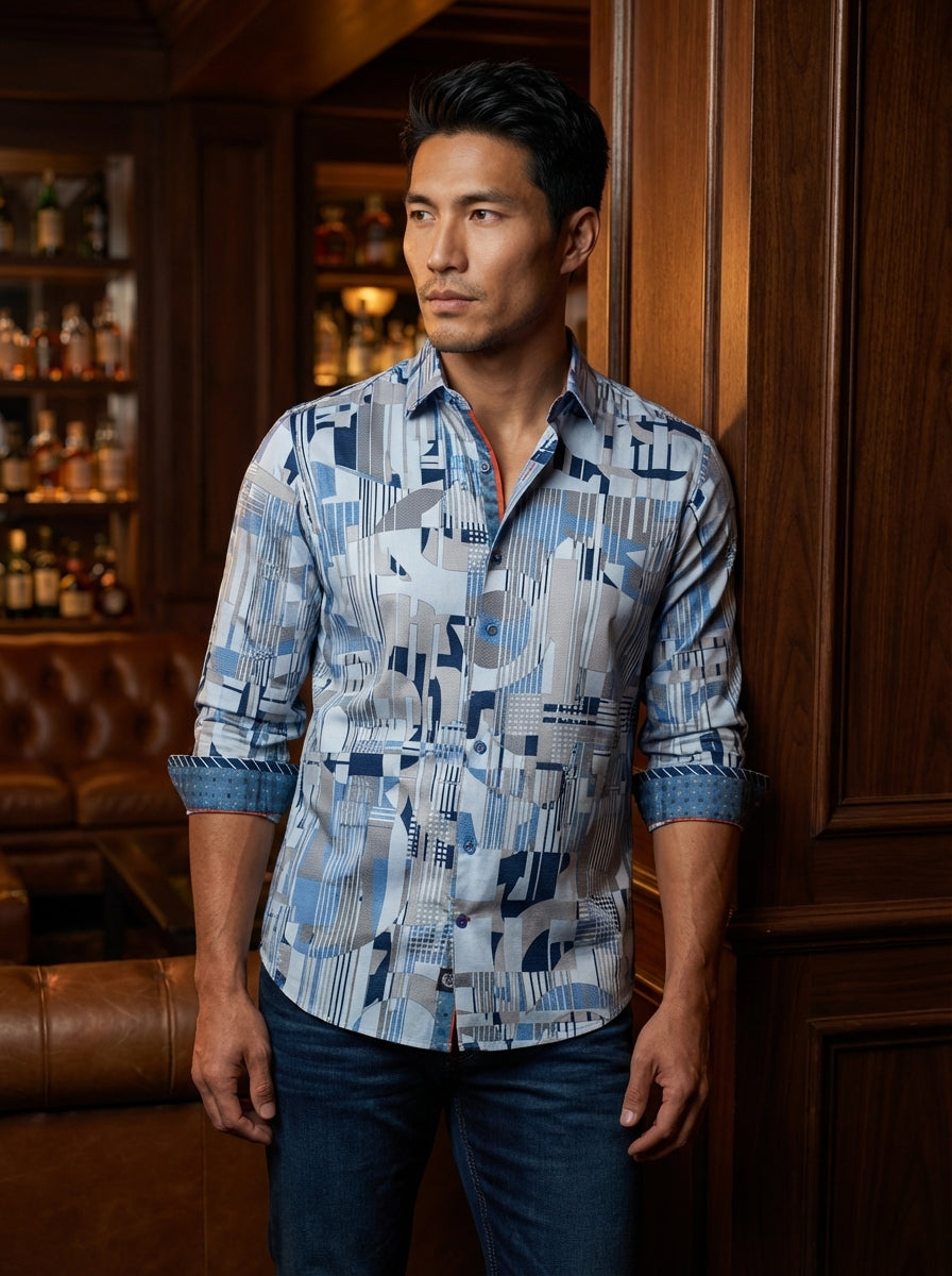 This contemporary men's button-down shirt features a dynamic geometric abstract print in shades of sky blue, navy, and slate grey. Detailed with contrast orange piping on the inner collar and cuffs, it offers a refined, modern tailored fit for versatility