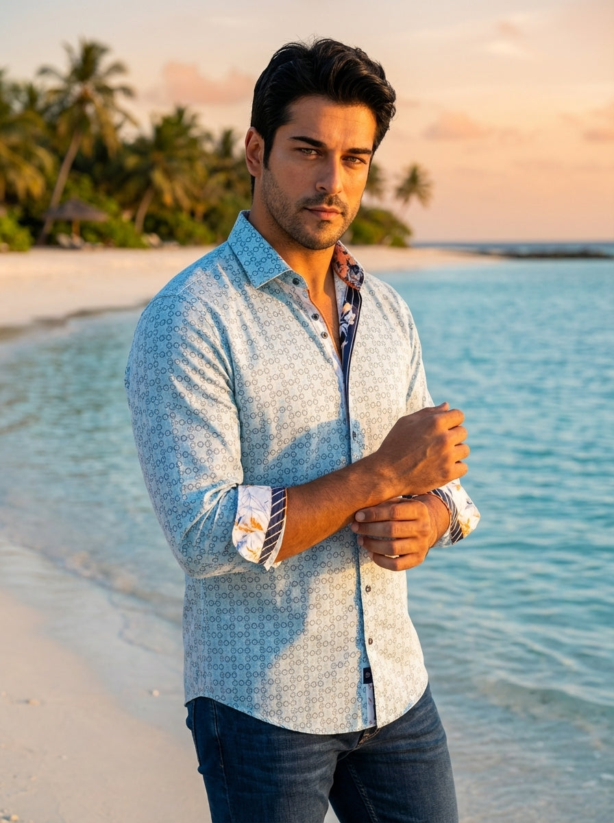 This tailored light blue button-down shirt features an intricate geometric circular pattern. Contrast floral and striped detailing on the inner collar and cuffs adds a sophisticated touch, while the high-quality cotton fabric ensures a sharp, comfortable 