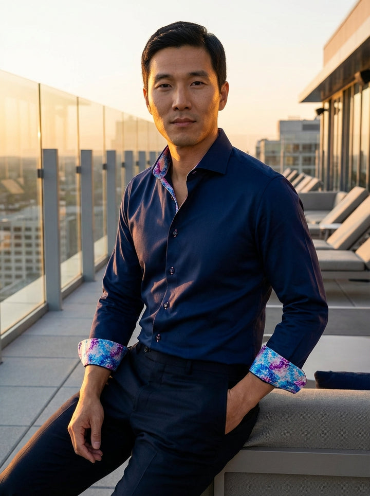 Crafted from premium deep navy fabric, this Masutto dress shirt features vibrant geometric patterns inside the collar and cuffs. Pink accent stitching on the buttons adds a playful touch, blending classic tailoring with contemporary, artistic details for 