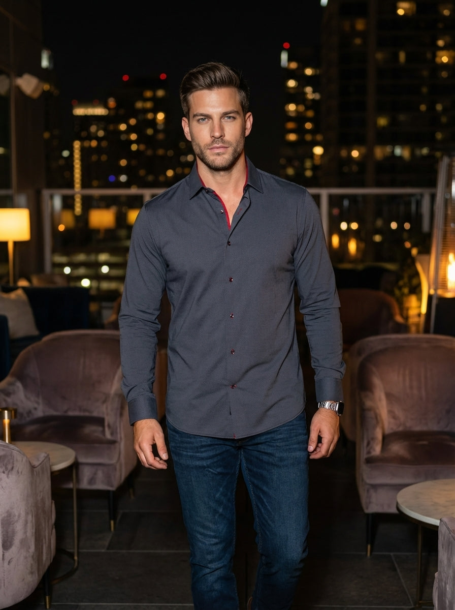 This sophisticated charcoal-grey button-down shirt features a subtle micro-textured pattern and a tailored fit. Contrasting red inner collar lining and matching thread on the buttons add a bold, modern edge, making it the perfect choice for upscale casual