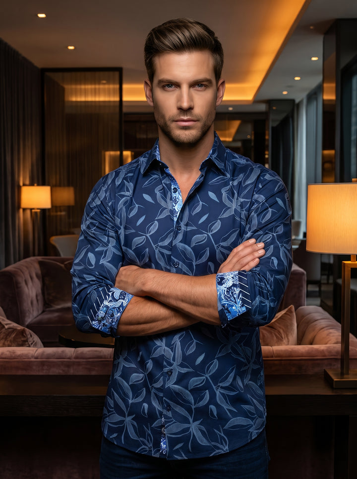 A sophisticated navy blue long-sleeved button-down shirt featuring an elegant light blue leaf and vine pattern. The design includes a contrasting ornate floral lining on the inner collar and cuffs, crafted from premium cotton for a sleek, tailored fit.