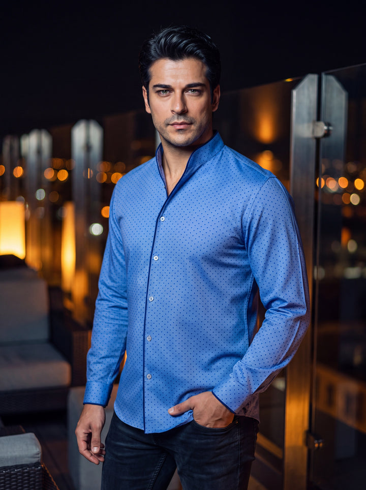 This sophisticated blue long-sleeve shirt features a distinctive mandarin collar and a refined micro-dot pattern. The design is elevated by contrasting navy blue piping along the placket and cuffs, offering a modern, tailored aesthetic for the style-consc