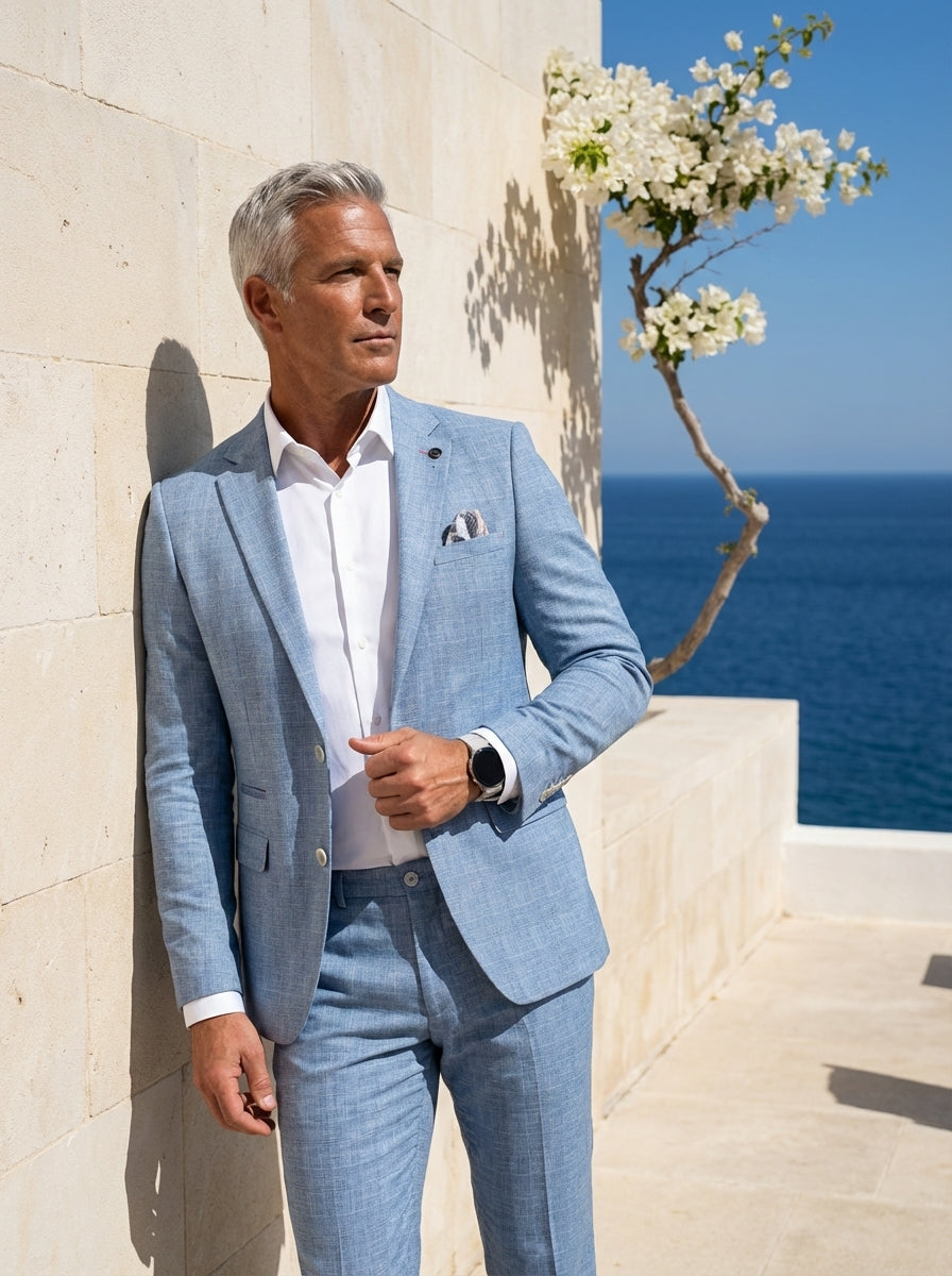 A sophisticated light blue two-piece suit crafted with a subtle textured pattern. This tailored ensemble features a single-breasted blazer with notch lapels, a crisp white dress shirt, and matching trousers for a sharp, modern silhouette ideal for formal 