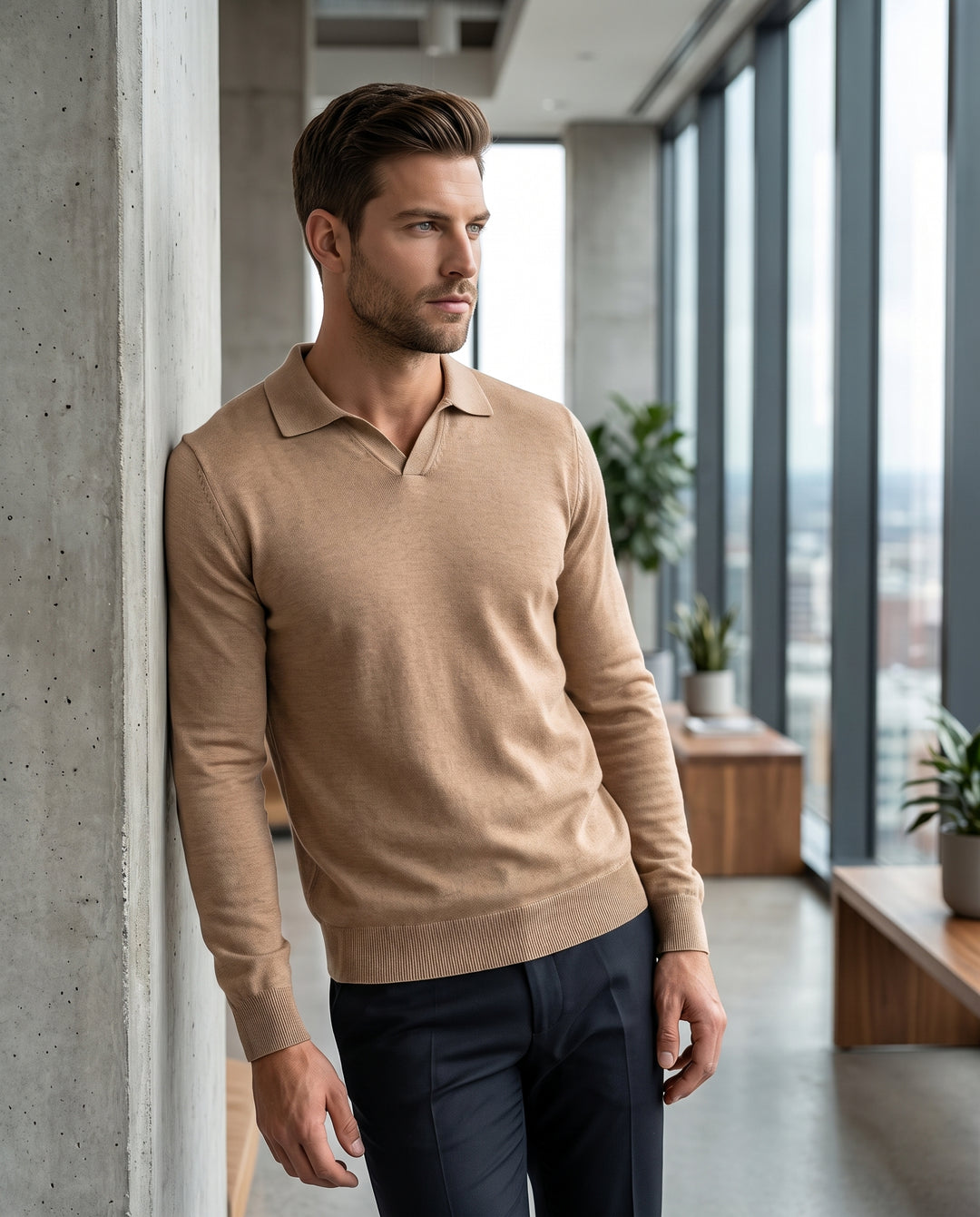 A men's long-sleeve knit polo in a warm camel or beige hue. It features a buttonless johnny collar, ribbed cuffs, and a ribbed hem, offering a streamlined, modern silhouette in a lightweight sweater fabric.