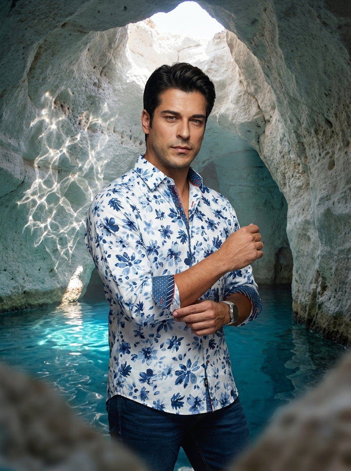 This men's long-sleeve button-up shirt features a crisp white base adorned with vibrant blue floral patterns. It includes sophisticated contrasting details on the inner collar and rolled cuffs, paired with a modern slim fit suitable for semi-formal or ups