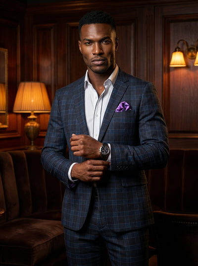 This sophisticated navy and charcoal plaid suit offers a modern slim-fit silhouette for the contemporary gentleman. Crafted from high-quality fabric, it features a notched lapel, a crisp white dress shirt with contrast piping, and a vibrant floral pocket 