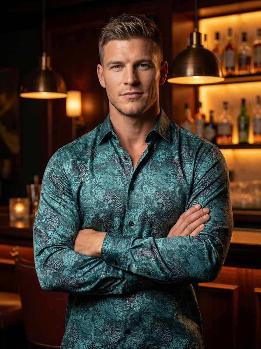 This teal long-sleeve button-down shirt features an intricate, all-over print of tigers and dragons weaving through stylized waves and clouds. Crafted from a smooth, lustrous fabric, it offers a regular fit with a classic collar and dark contrasting butto