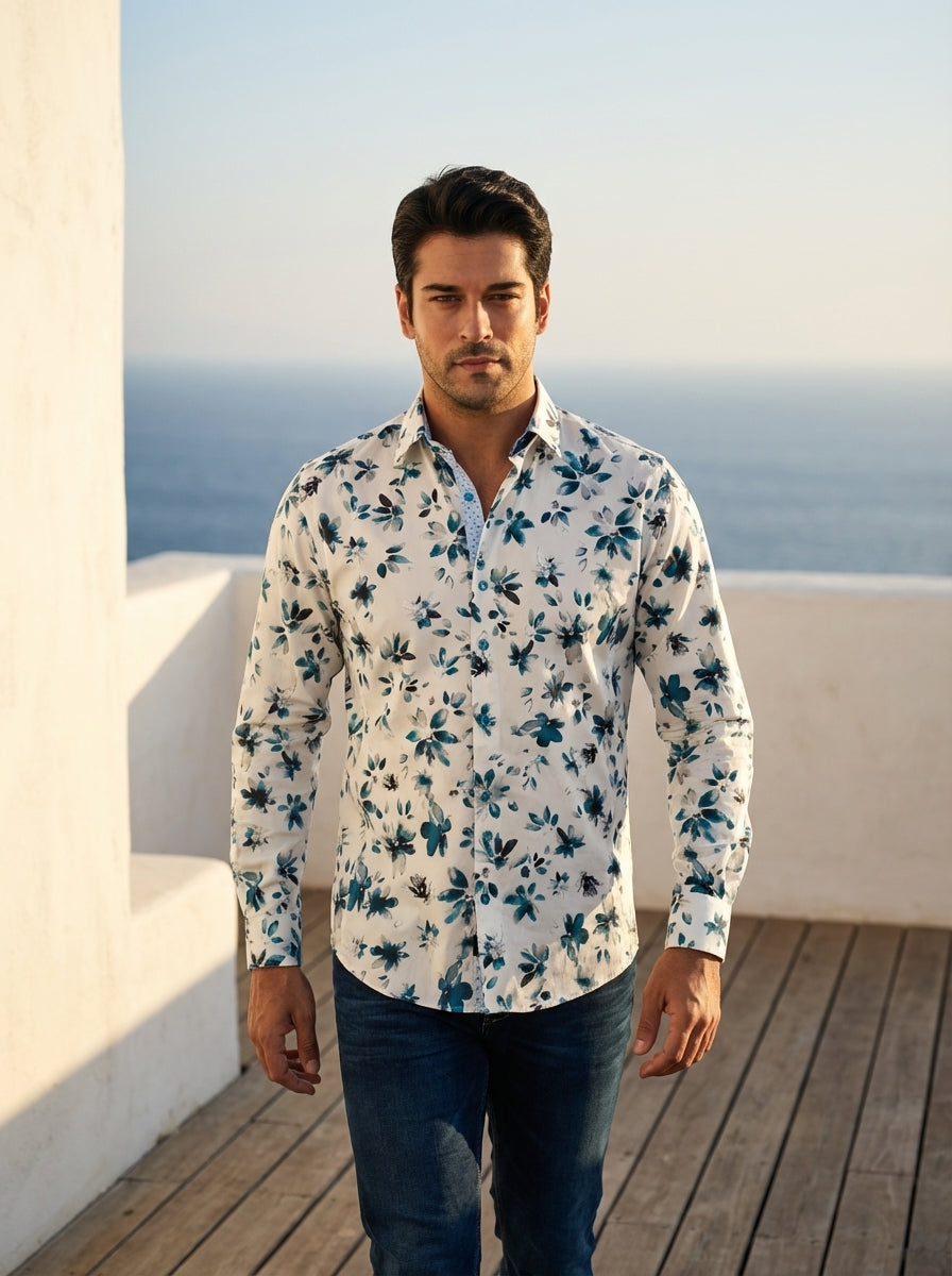 This men's long-sleeve button-down shirt features a sophisticated white base adorned with a watercolor floral print in teal and navy. The design includes a contrast inner collar and cuffs, adding a modern, structured touch to the artistic botanical patter