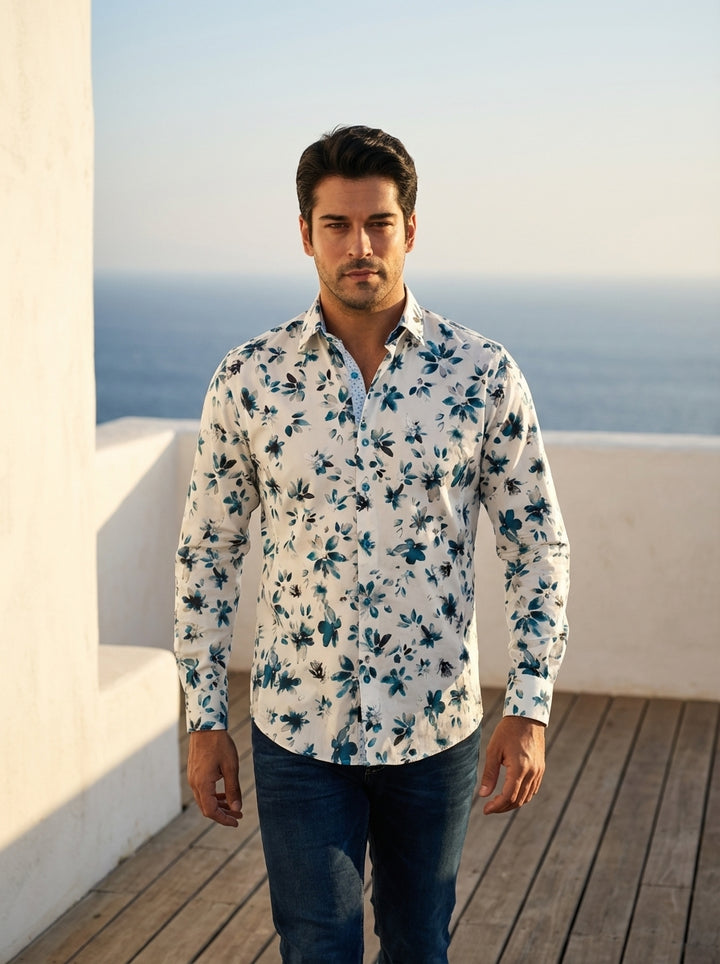 This men's long-sleeve button-down shirt features a sophisticated white base adorned with a watercolor floral print in teal and navy. The design includes a contrast inner collar and cuffs, adding a modern, structured touch to the artistic botanical patter