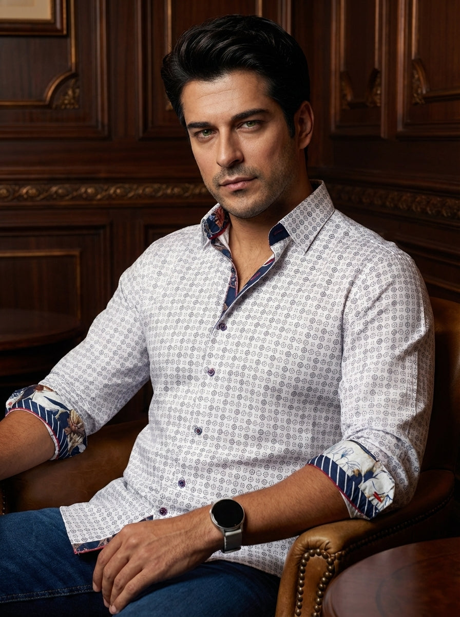 This sophisticated white button-down shirt features an intricate geometric micro-print throughout. Contrast lining on the collar and cuffs showcases a vibrant floral and striped pattern, adding a modern twist. Tailored for a crisp fit, it offers premium s