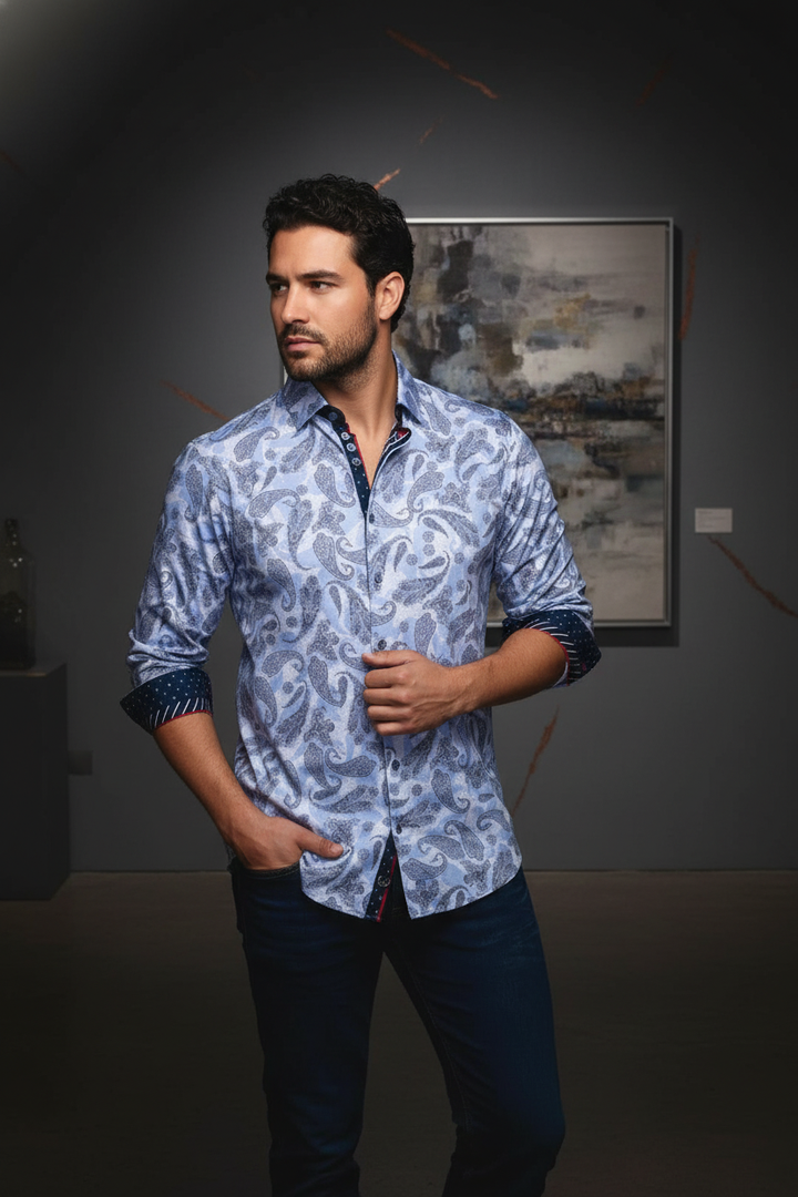 Sophisticated men's light blue paisley patterned long-sleeve shirt. Features contrasting dark blue cuffs and inner placket with subtle red accents, perfect for a refined and stylish look.