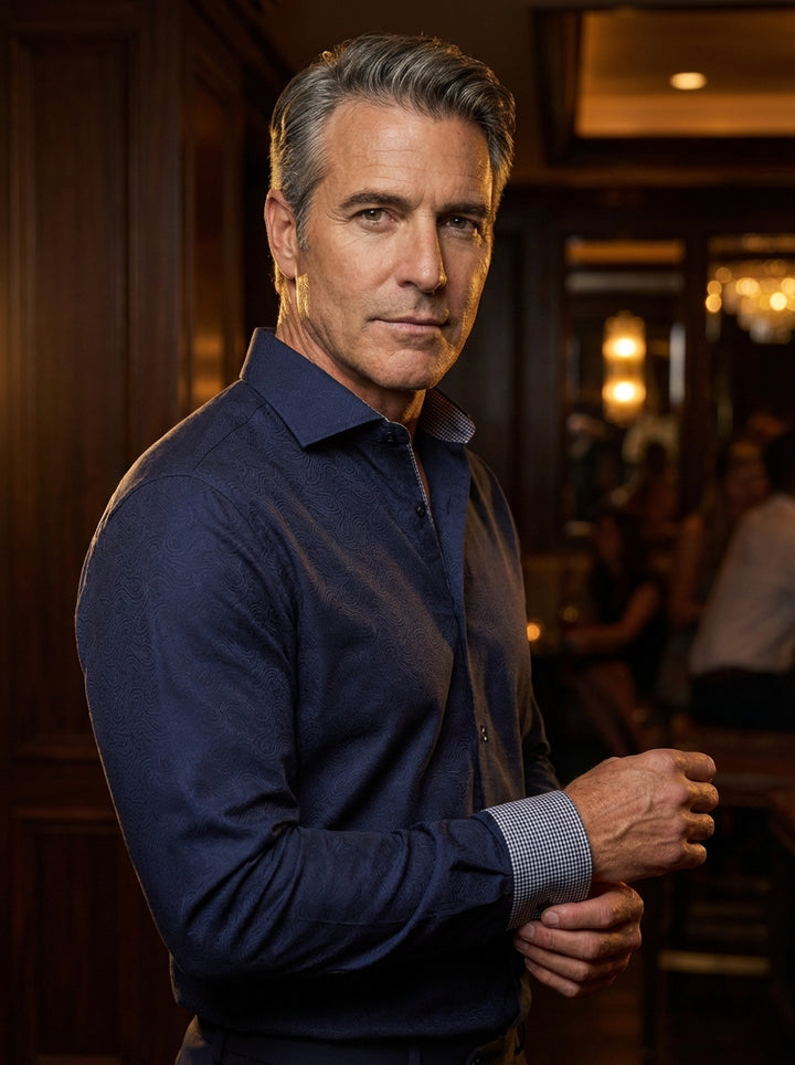 This sophisticated black dress shirt features a subtle, tonal paisley jacquard pattern throughout. Crafted with a classic pointed collar and contrasting micro-check inner lining on the collar and cuffs, it offers a refined twist on a timeless wardrobe ess