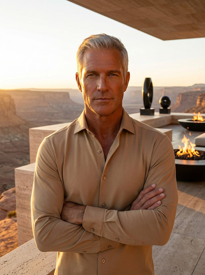 This men's long-sleeve button-down shirt is crafted from a smooth, tan-colored jersey fabric that offers a modern, tailored fit. Featuring a classic spread collar, button cuffs, and a curved hem, it seamlessly blends comfort with a polished, sophisticated