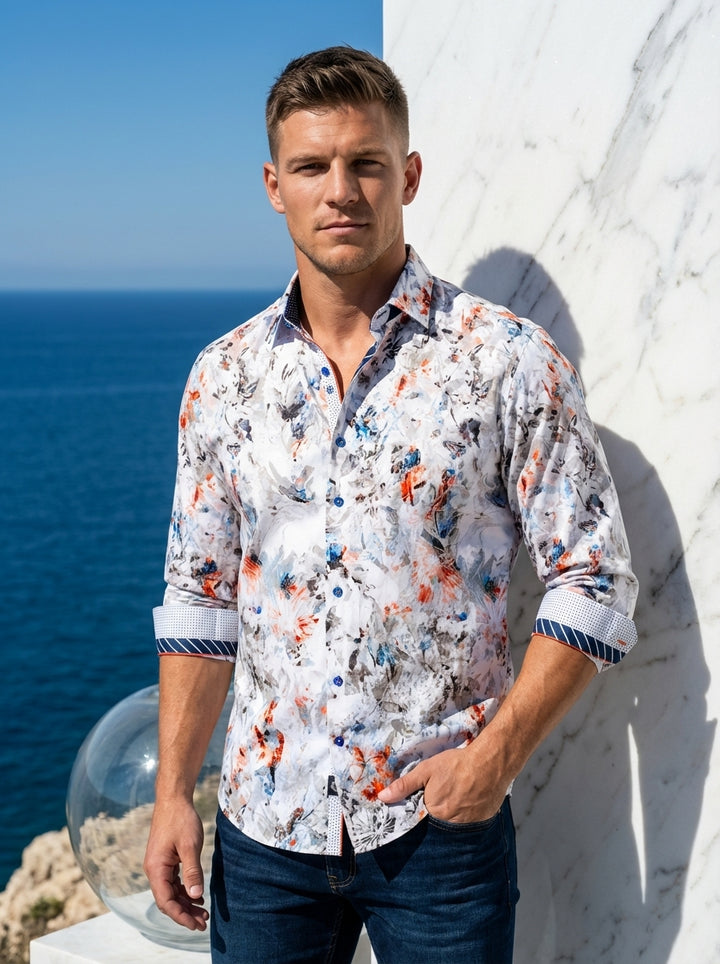 This men's long-sleeve button-down features a vibrant, multi-colored abstract floral print on a white base. It boasts intricate contrast detailing on the inner collar and cuffs, including navy stripes and micro-dots, paired with blue buttons for a sophist
