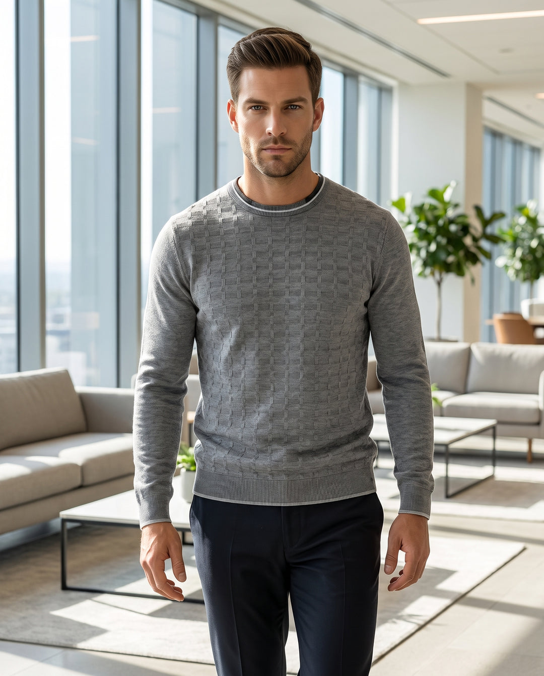 This men's grey crewneck sweater features a subtle, tonal checkered knit pattern for added texture. It includes a layered-look ribbed collar with white tipping and matching ribbed cuffs and hem, offering a modern and polished smart-casual aesthetic.