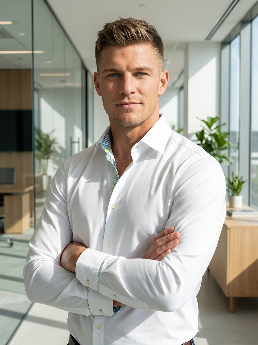 This crisp white dress shirt by Bertigo features a classic spread collar and tonal buttons. Subtle contrast geometric blue and lime green patterning lines the interior collar and cuffs, adding a modern, sophisticated twist to a staple professional garment