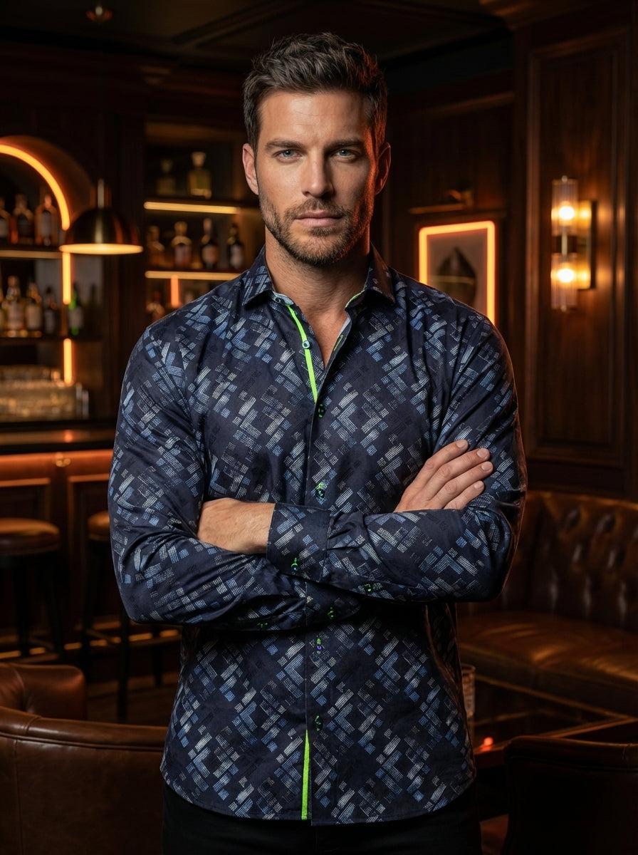 This navy long-sleeve button-down shirt features an intricate geometric block print in shades of light blue and grey. Designed with a modern fit, it includes vibrant lime green contrast piping along the inner placket and button stitching for a contemporar