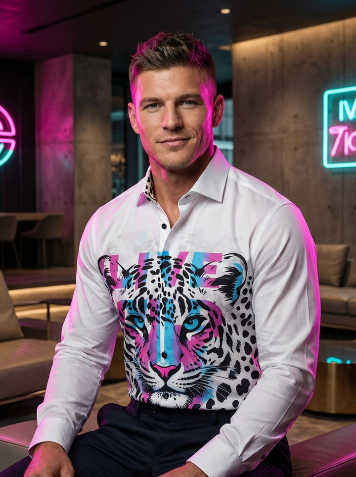A bold white button-down shirt featuring a vibrant, artistic graphic print of a feline face integrated with colorful typography. The design includes striking pink and blue gradients, black leopard-style spots, and contrasting black buttons for a high-ener
