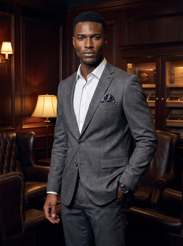 This sophisticated two-piece suit features a charcoal grey crosshatch pattern with a slim-fit silhouette. The blazer includes a notched lapel and a patterned pocket square, paired with a crisp white dress shirt featuring contrast piping for a modern, refi