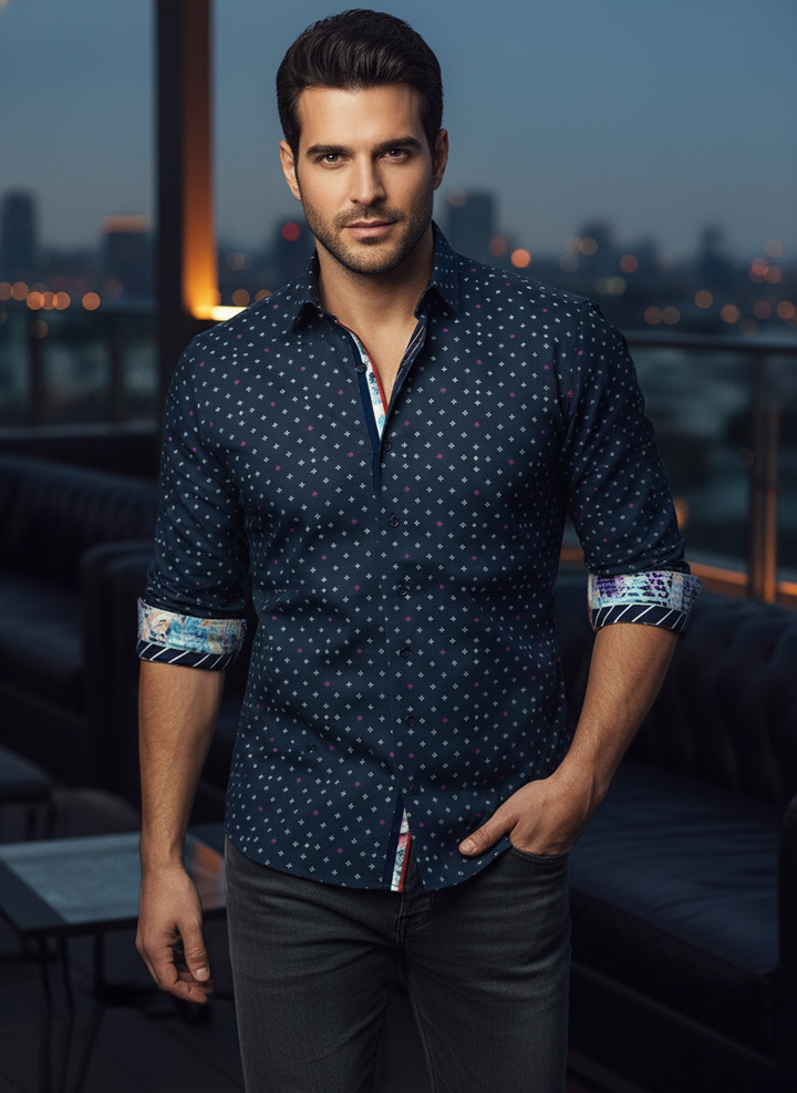 This navy long-sleeved shirt features a subtle geometric micro-print, accented by vibrant, multi-tonal floral cuff linings and a contrasting striped placket. Meticulously tailored for a modern fit, it blends classic elegance with a bold, contemporary edge