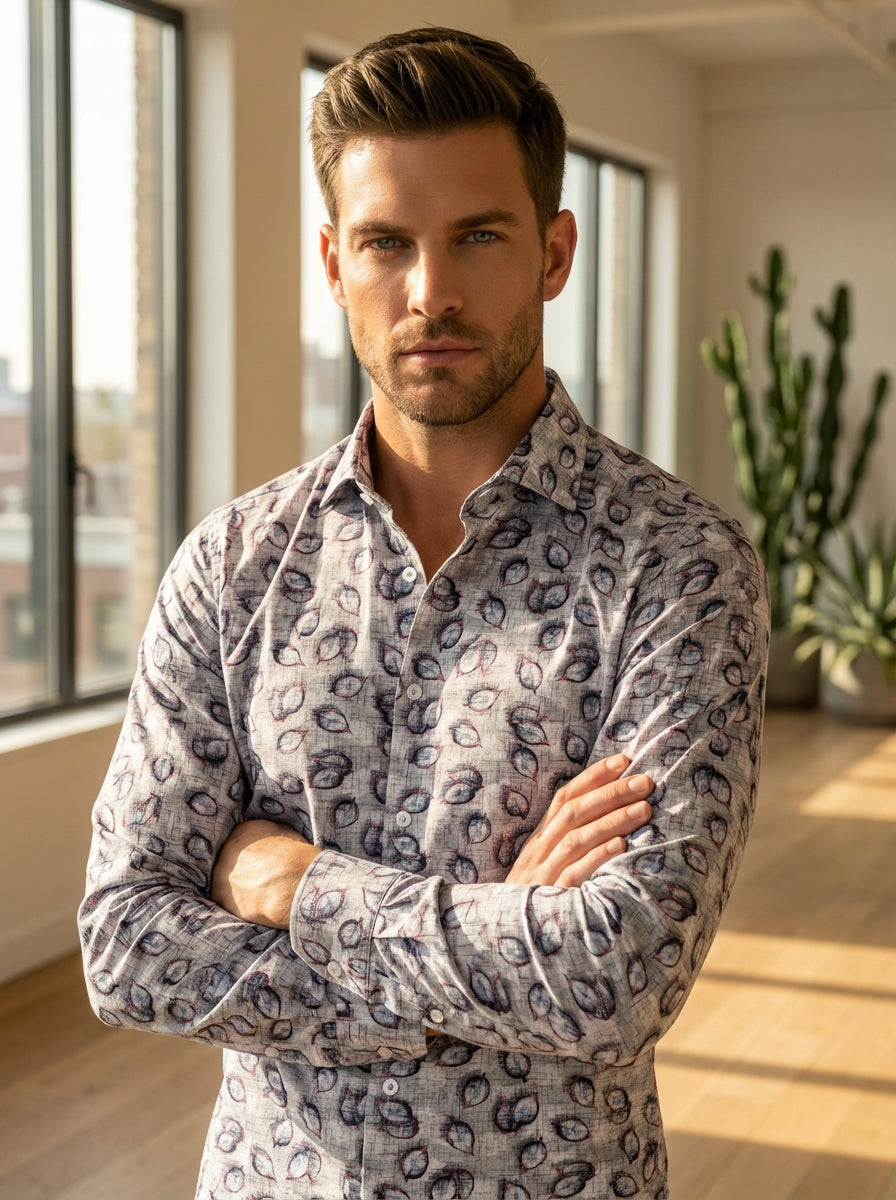 This Masutto long-sleeved button-down shirt features a sophisticated grey cross-hatch base adorned with artistic, sketch-style leaf motifs in shades of blue and burgundy. Crafted with a tailored fit, it offers a contemporary blend of classic structure and