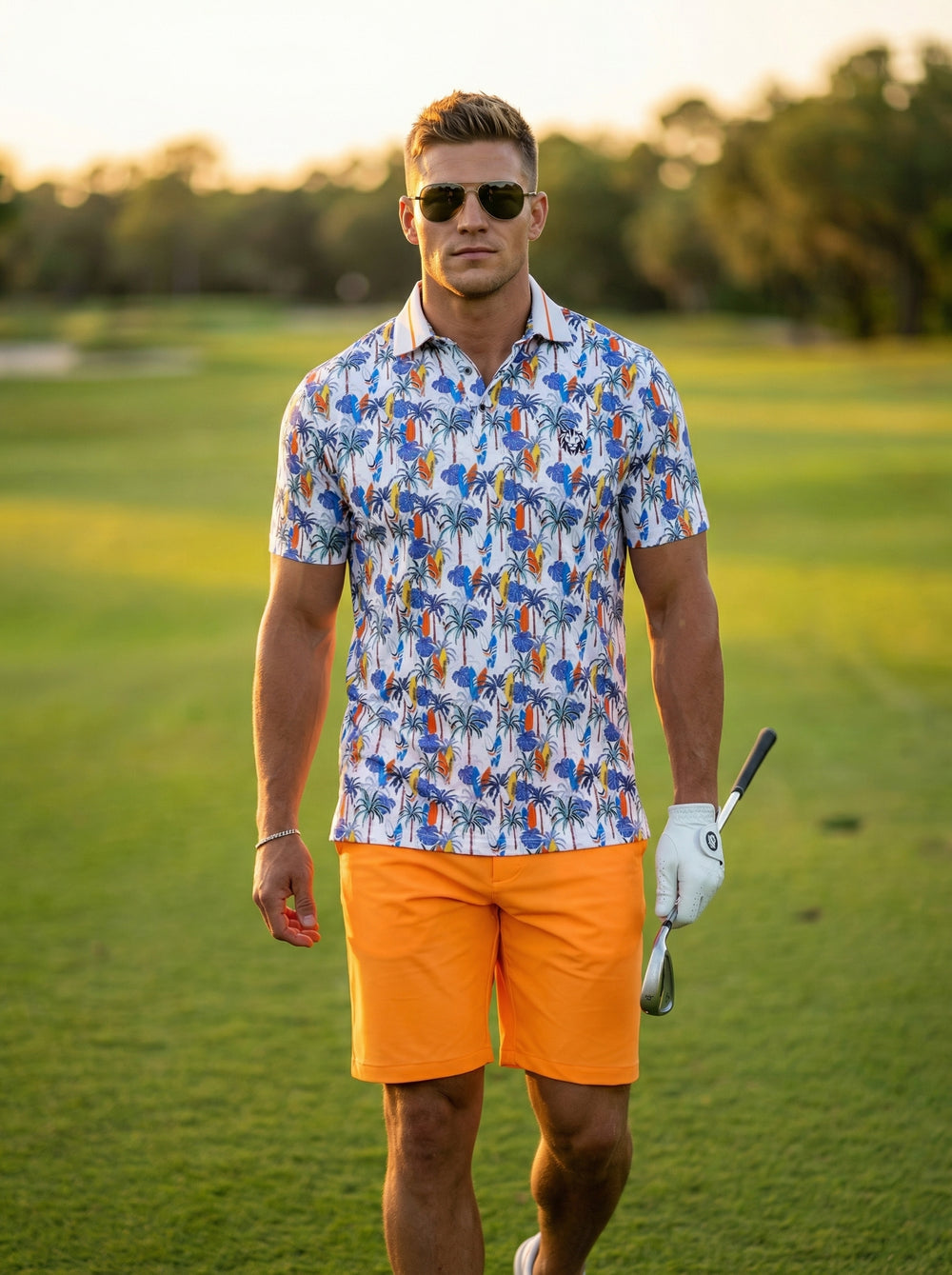 This men's short-sleeve performance polo features a vibrant tropical print with palm trees and surfboards on a crisp white base. Paired with bright orange shorts, the moisture-wicking fabric and tailored fit offer a comfortable, stylish look for warm-weat